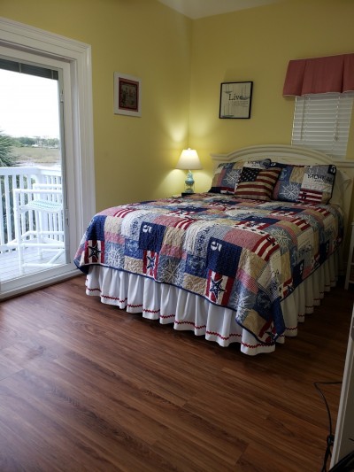 second bedroom with balcony overlooking pool